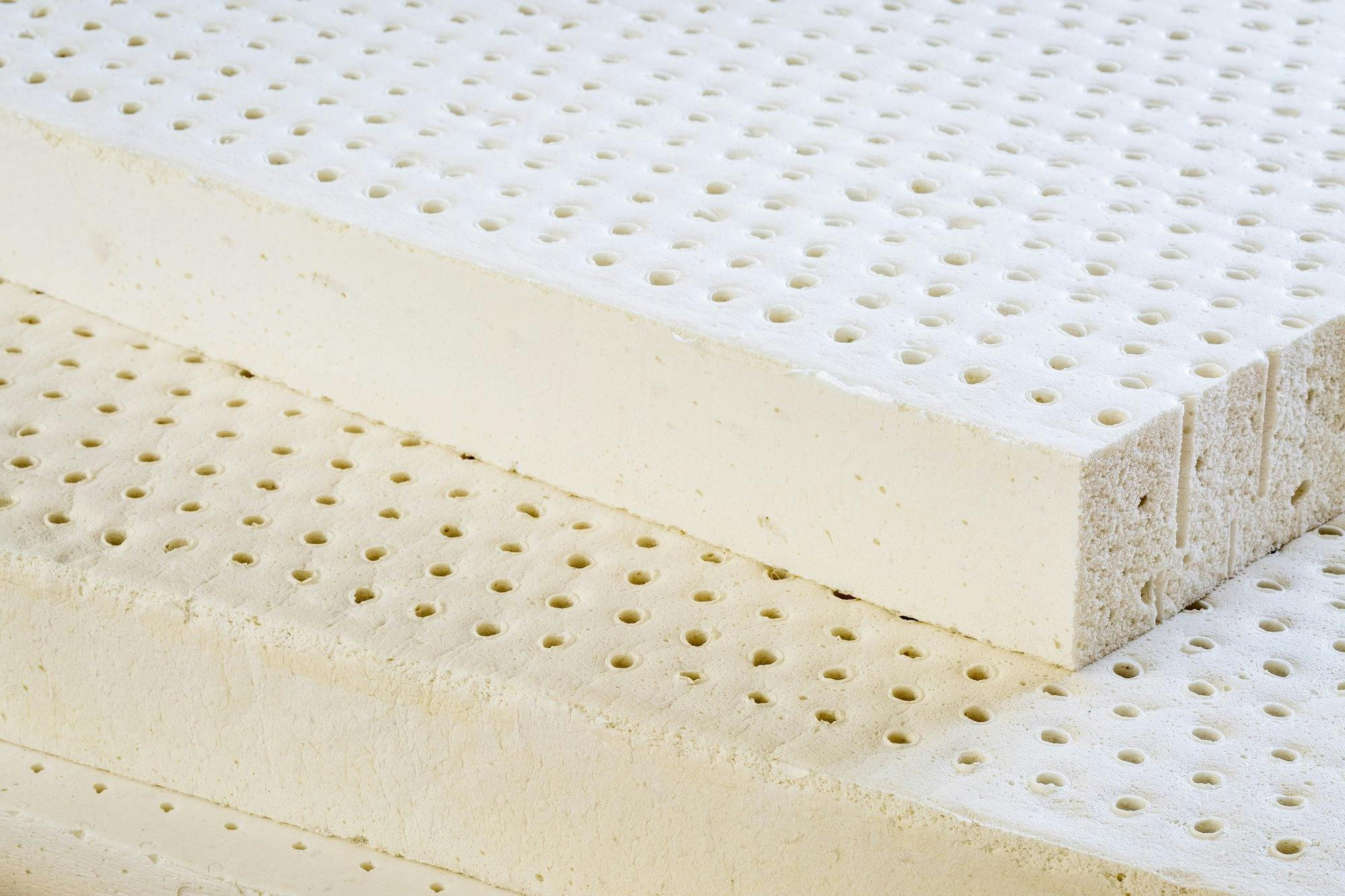 Hole-punched latex foam layers